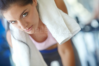 Buy stock photo Closeup of a young woman exercising with a towel around her neck
