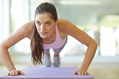 Buy stock photo A beautiful young woman doing push-ups