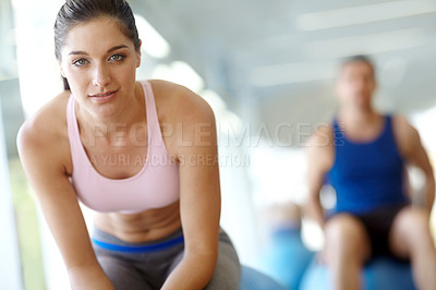 Buy stock photo Two people doing exercises on Swiss balls at the gym