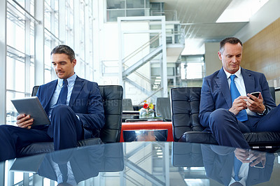 Buy stock photo Relax, technology and search with business people in lounge with phone and tablet for contact, internet or email. Search, networking and communication with male employee in lobby of corporate company