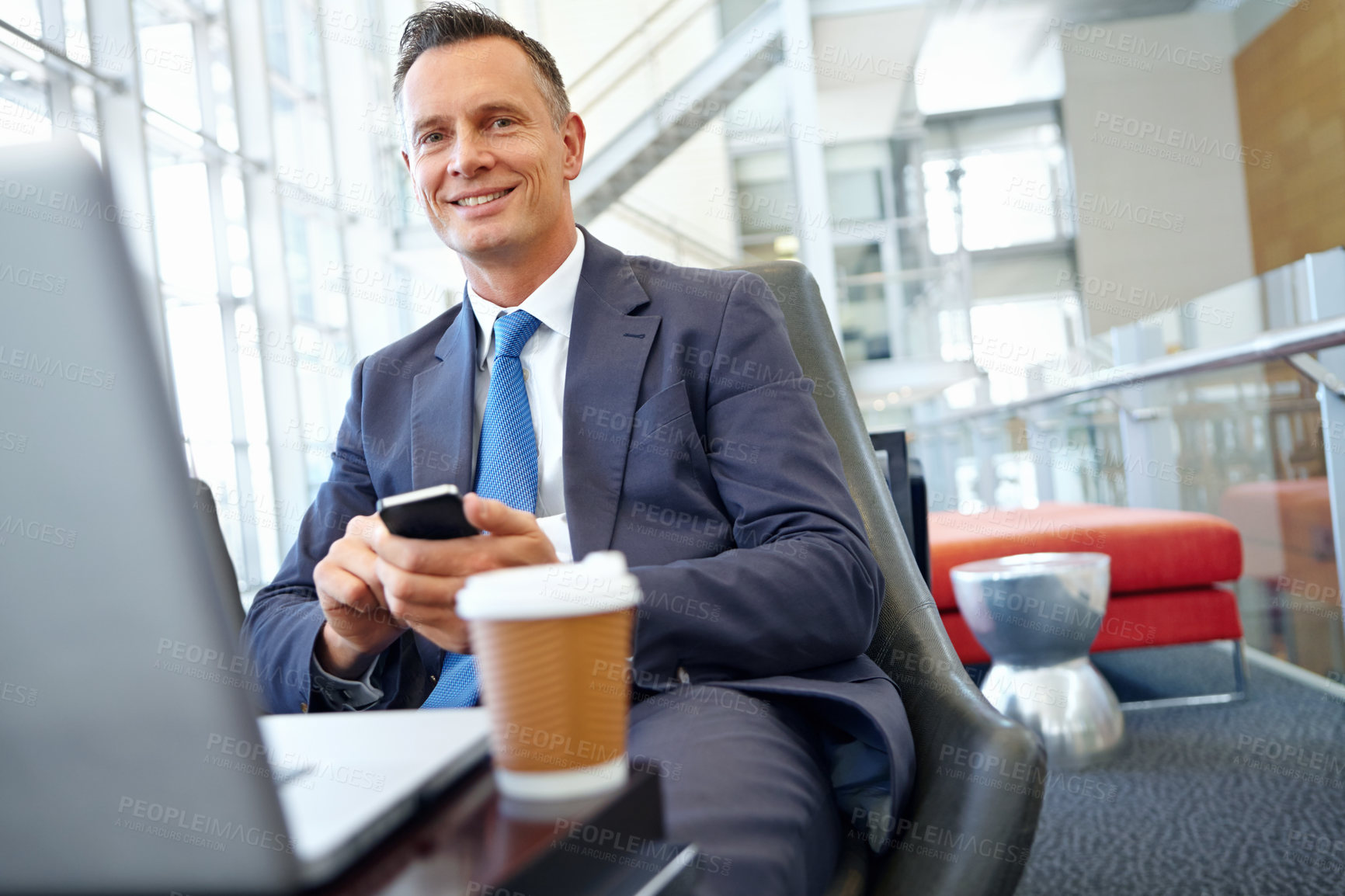 Buy stock photo Businessman smile, laptop and smartphone with company communication or social media with coffee while working. Contact, online and email with networking and worker in professional corporate lounge