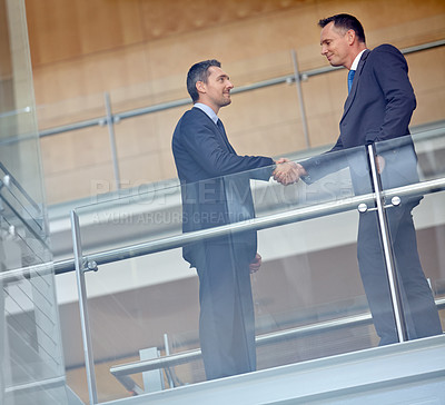 Buy stock photo Low angle, business people and corporate handshake in modern office, finance company and investment deal startup. Men, shaking hands and partnership gesture for insurance workers in welcome greeting