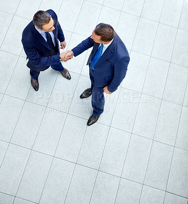 Buy stock photo Top view, business people or handshake in modern office, finance company or investment startup for insurance deal. Men, shaking hands or partnership gesture for corporate workers in welcome greeting