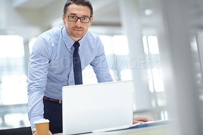 Buy stock photo Portrait, laptop and mission with a business man at work in his office for research or innovation. Computer, mindset and vision with a male employee working on a report or planning for success