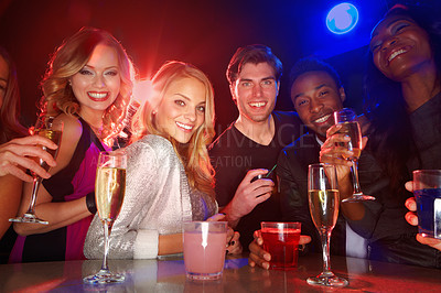 Buy stock photo Portrait, clubbing and drinking with friends together in a nightclub for a new year celebration party. Happy, drink and cocktail with a man and woman friend group bonding in a nightclub for fun