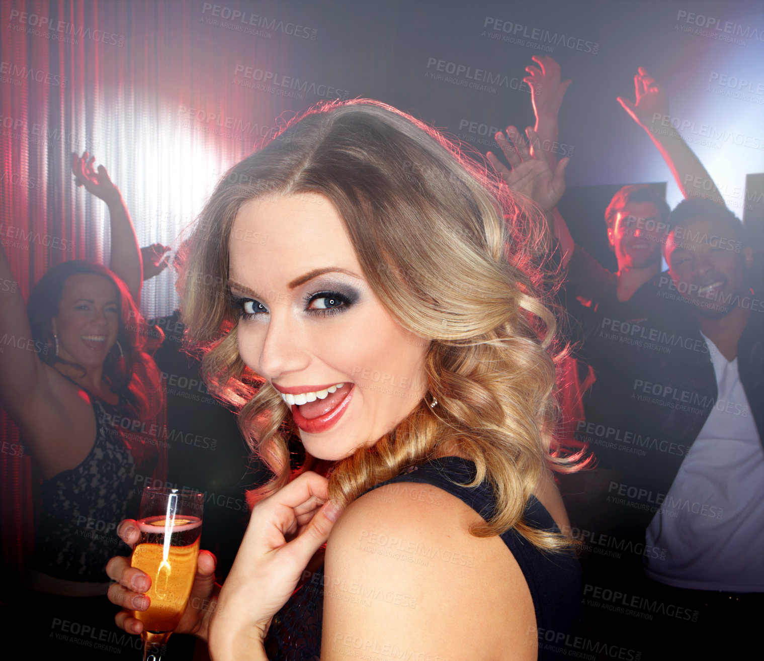 Buy stock photo A lovely young blonde woman smiling at the camera while standing on the dancefloor holding a glass of wine