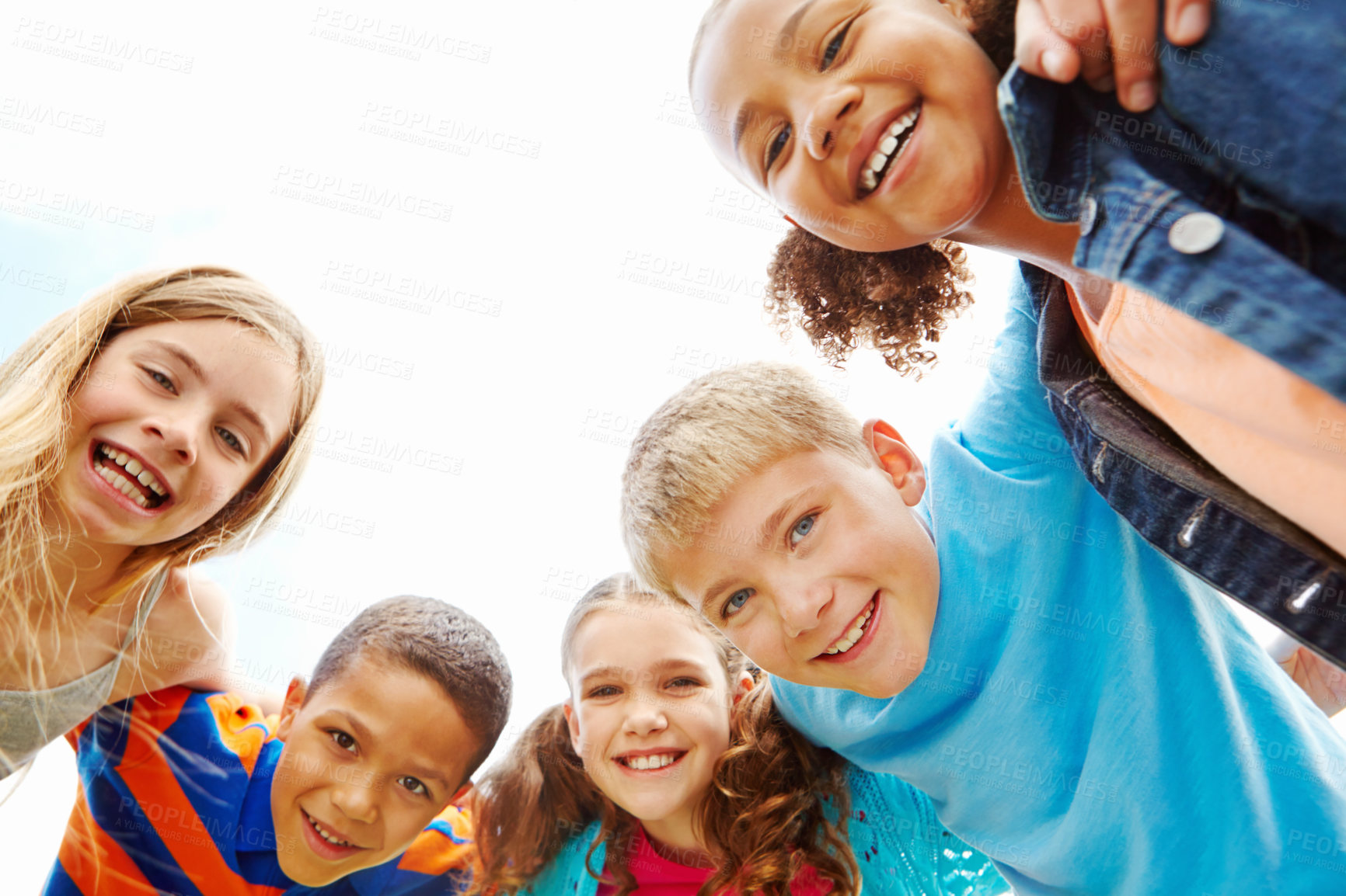 Buy stock photo Multi-ethnic group of smiling children in a huddle
