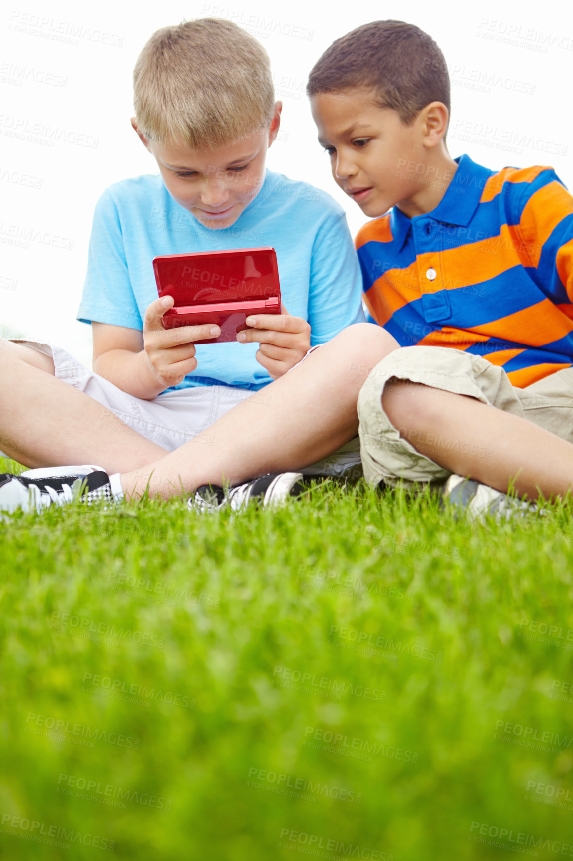 Buy stock photo Outdoor, friends and kids with gaming console for playing together, video games and bonding in park. Boys, field and children with portable technology for entertainment, fun or development growth