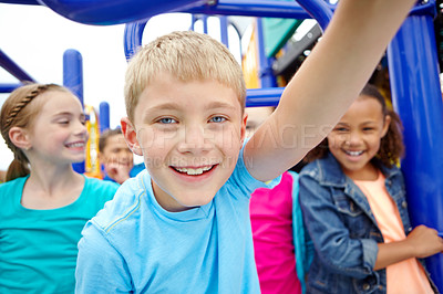 Buy stock photo A multi-ethnic group of happy children playing on a jungle gym in a play park