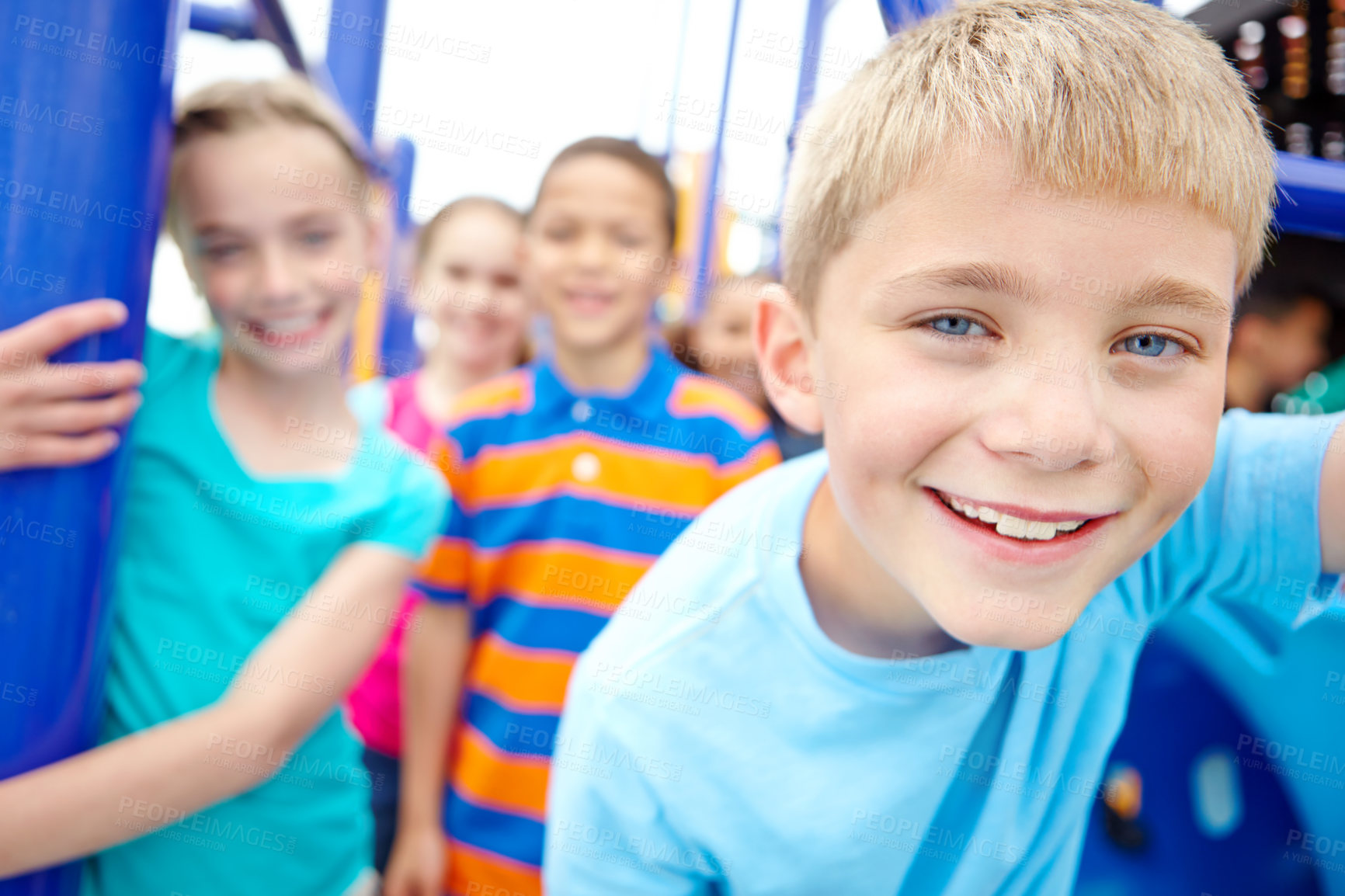 Buy stock photo A multi-ethnic group of happy children playing on a jungle gym in a play park