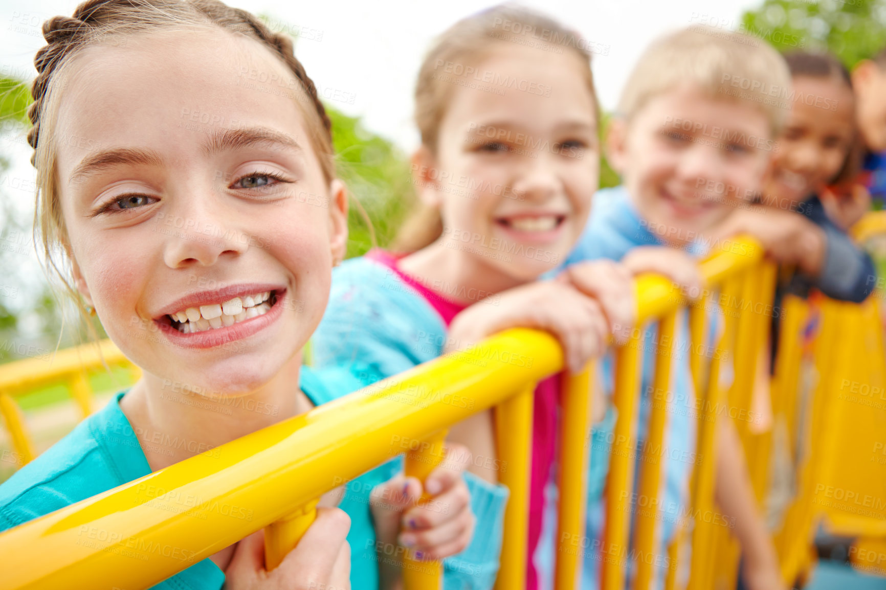 Buy stock photo A multi-ethnic group of happy children playing on a jungle gym in a play park