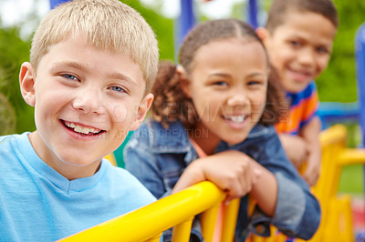 Buy stock photo A multi-ethnic group of happy children playing on a jungle gym in a play park