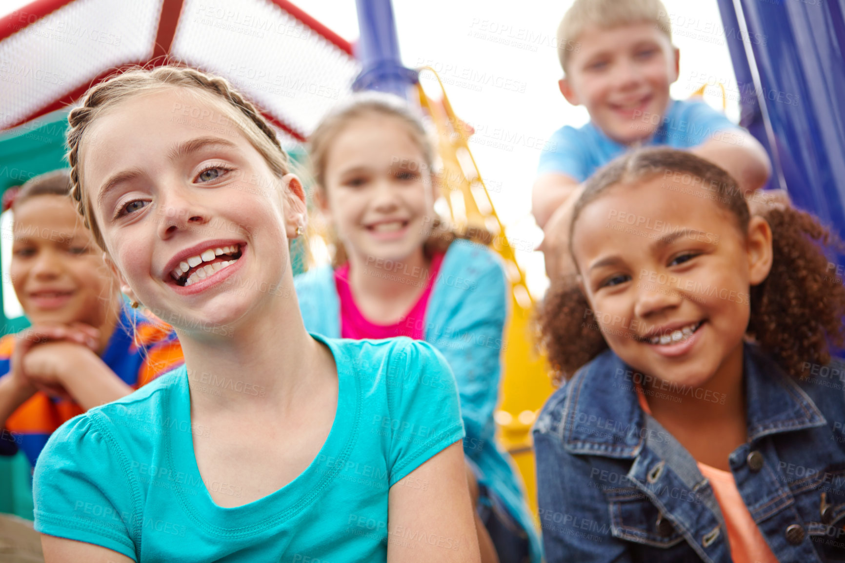 Buy stock photo A multi-ethnic group of happy children playing on a jungle gym in a play park