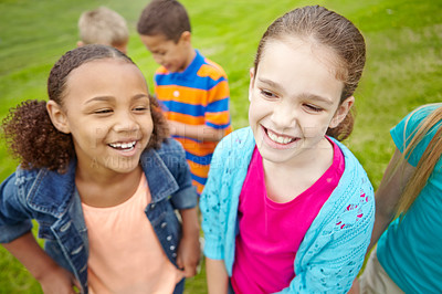 Buy stock photo A multi-ethnic group of kids standing outside in a park