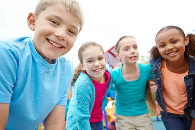 Buy stock photo A group of kids standing on the playground smiling at the camera