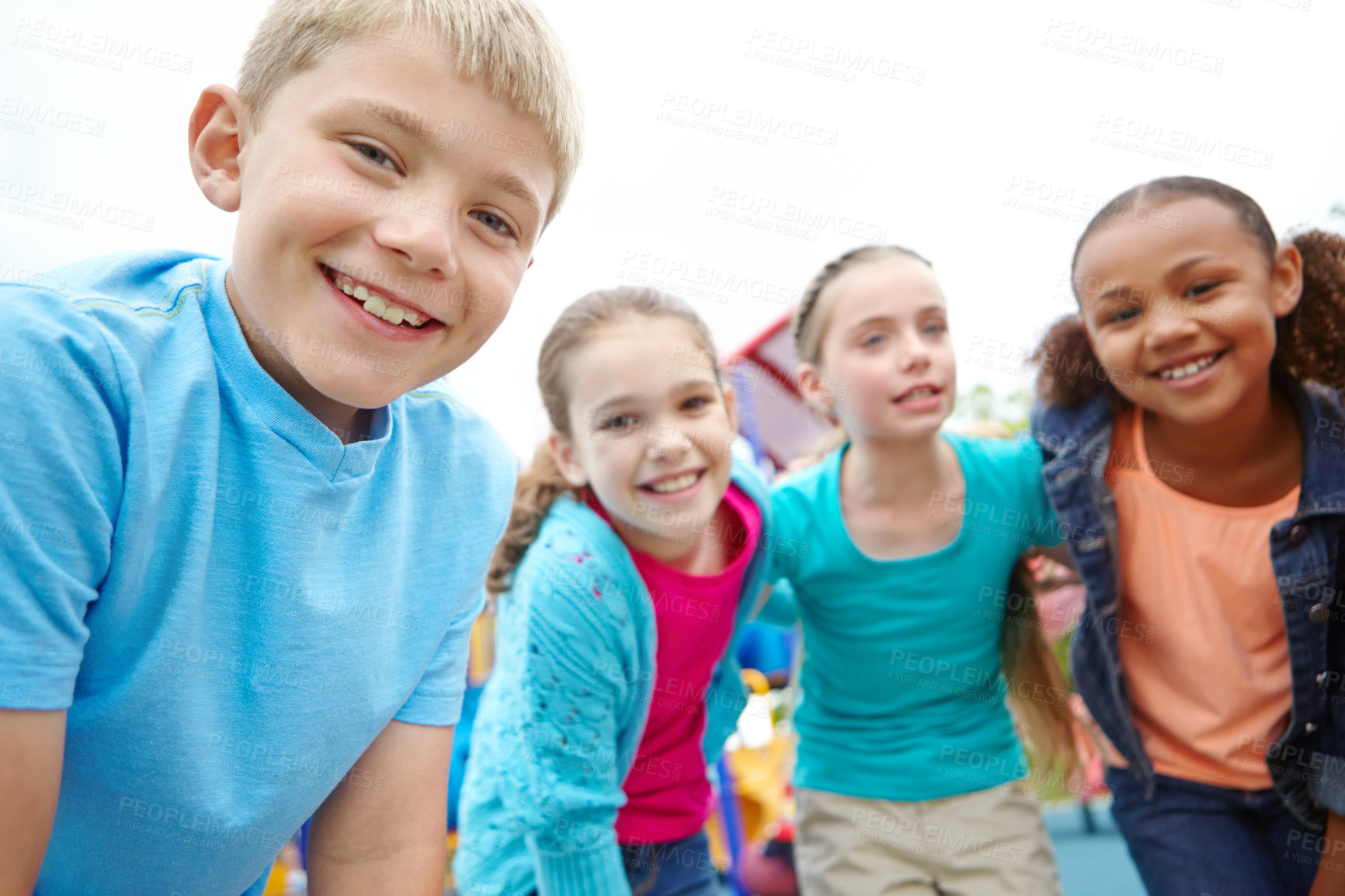 Buy stock photo A group of kids standing on the playground smiling at the camera