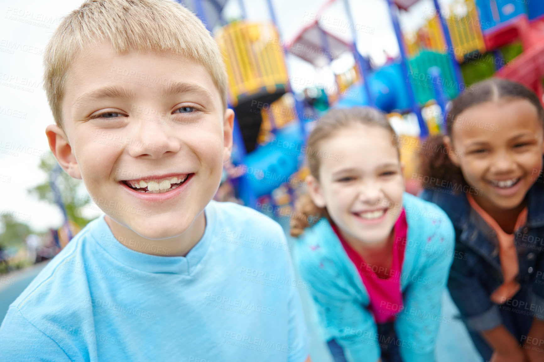 Buy stock photo A group of kids standing on the playground smiling at the camera