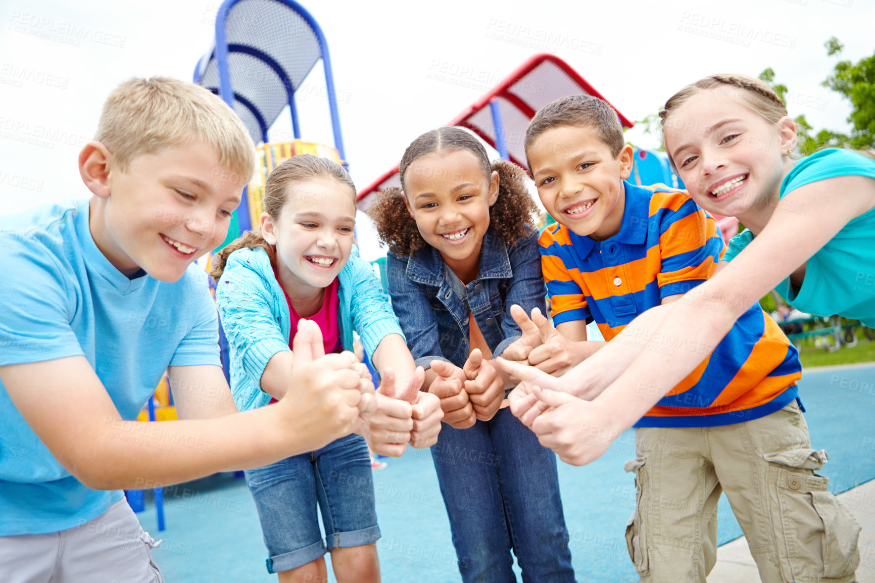 Buy stock photo A group of kids standing on a playground showing a thumbs-up to the camera