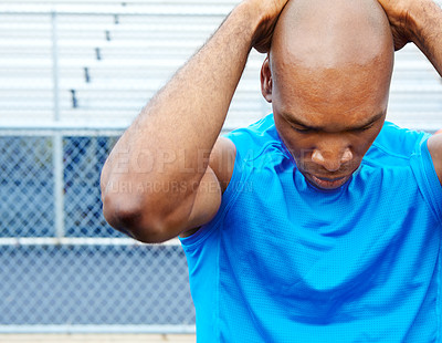 Buy stock photo Close up shot of a male athlete touching his head with focus