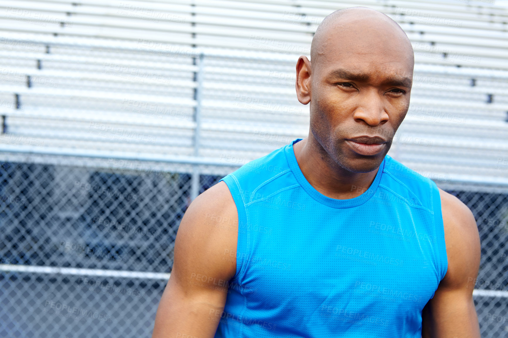 Buy stock photo Head and shoulders shot of a male runner at the sports track