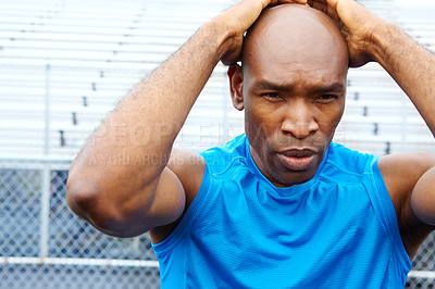 Buy stock photo Close up portrait of a male athlete touching his head in concentration