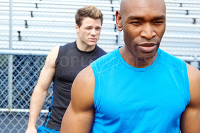 Buy stock photo Close up of two male runners wearing sports gear and preparing for the race