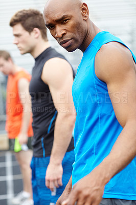 Buy stock photo Man, portrait and fitness with runner in line for race, sprint or marathon on stadium track. Male person, row or getting ready with warm up for exercise, running competition or outdoor training