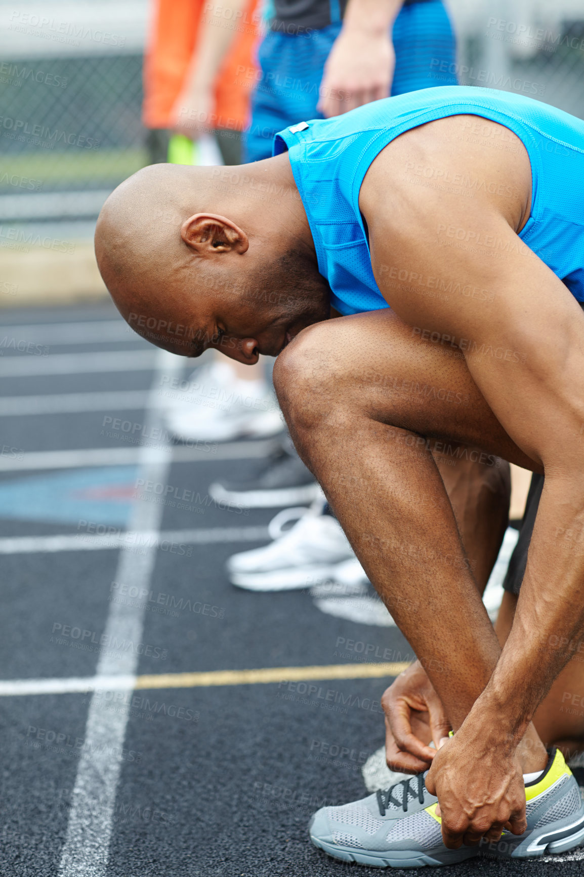 Buy stock photo Man, fitness and tying with shoes on stadium track for running competition, sprint or race. Male person, runner or athlete getting ready with tie or laces for workout, exercise or outdoor training