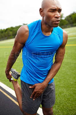 Buy stock photo Close up shot of a male athlete warming up at the race track
