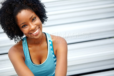 Buy stock photo Cropped shot of a female athlete smiling at the camera while sitting on the rafters