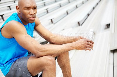 Buy stock photo Cropped close up of a male runner sitting on the rafters and looking away from the camera