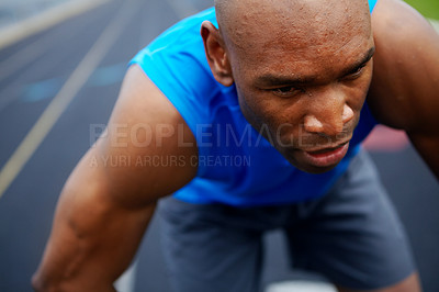 Buy stock photo Cropped close up of a male athlete at the beginning of the track