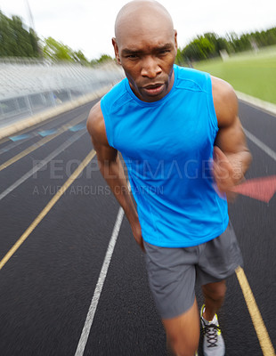 Buy stock photo Cropped front view of a focused male athlete running on the track