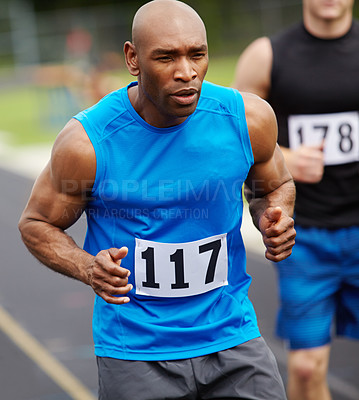 Buy stock photo Cropped front view of a male runner at the start of the race with his competitor number displayed on his sport shirt