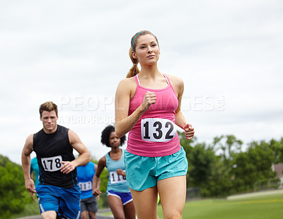 Buy stock photo Front view of a determined female runner in first place