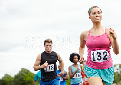 Buy stock photo Cropped shot of a driven female runner in first place