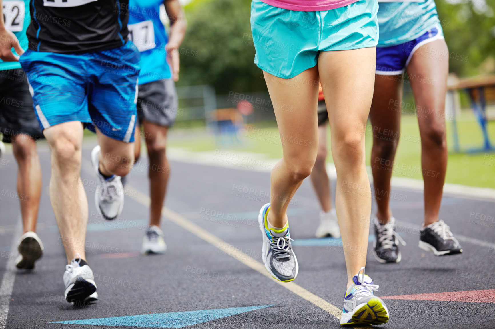 Buy stock photo Sports, legs and group of athletes running on track for race, challenge or marathon with speed. Fitness, energy and body of people with energy for cardio workout, exercise or training at stadium.