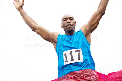 Buy stock photo Low angle view of a successful runner reaching the ribbon