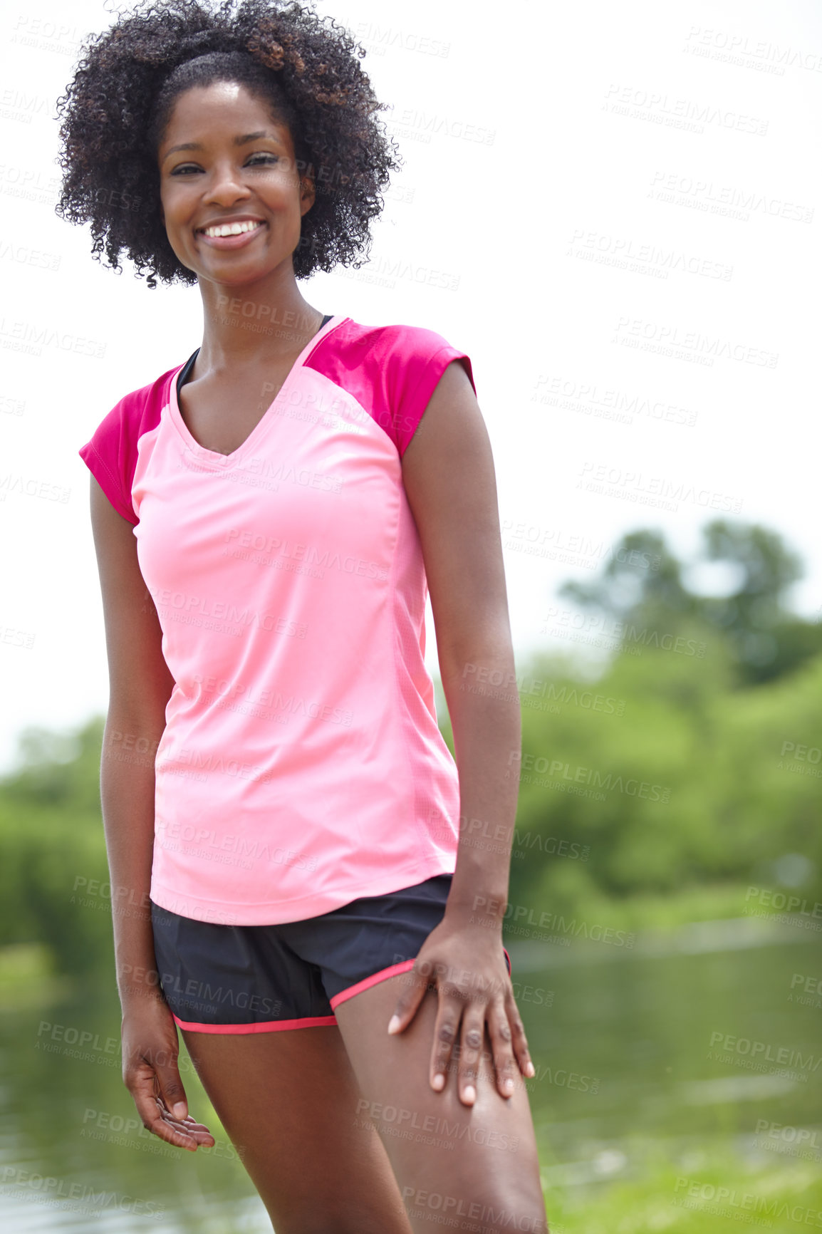 Buy stock photo Cropped portrait of a female athlete smiling widely and standing outdoors in a casual stance