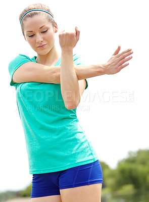 Buy stock photo Cropped shot of a female athlete standing outdoors and stretching