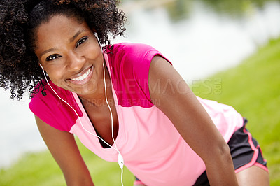 Buy stock photo Cropped close up of a female jogger leaning forward and looking at the camera while smiling widely