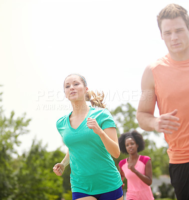 Buy stock photo Cropped shot of a group of athletes running outdoors