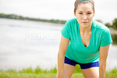 Buy stock photo Portrait of a female athlete standing outdoors and leaning forward