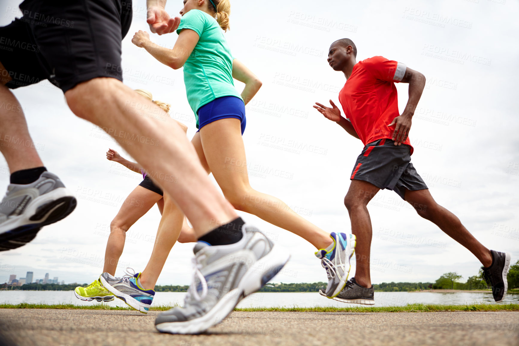 Buy stock photo Low angle side view of athletes running a race