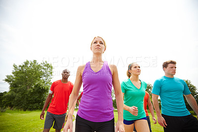 Buy stock photo Low angle shot of a group of athletes exercising outdoors