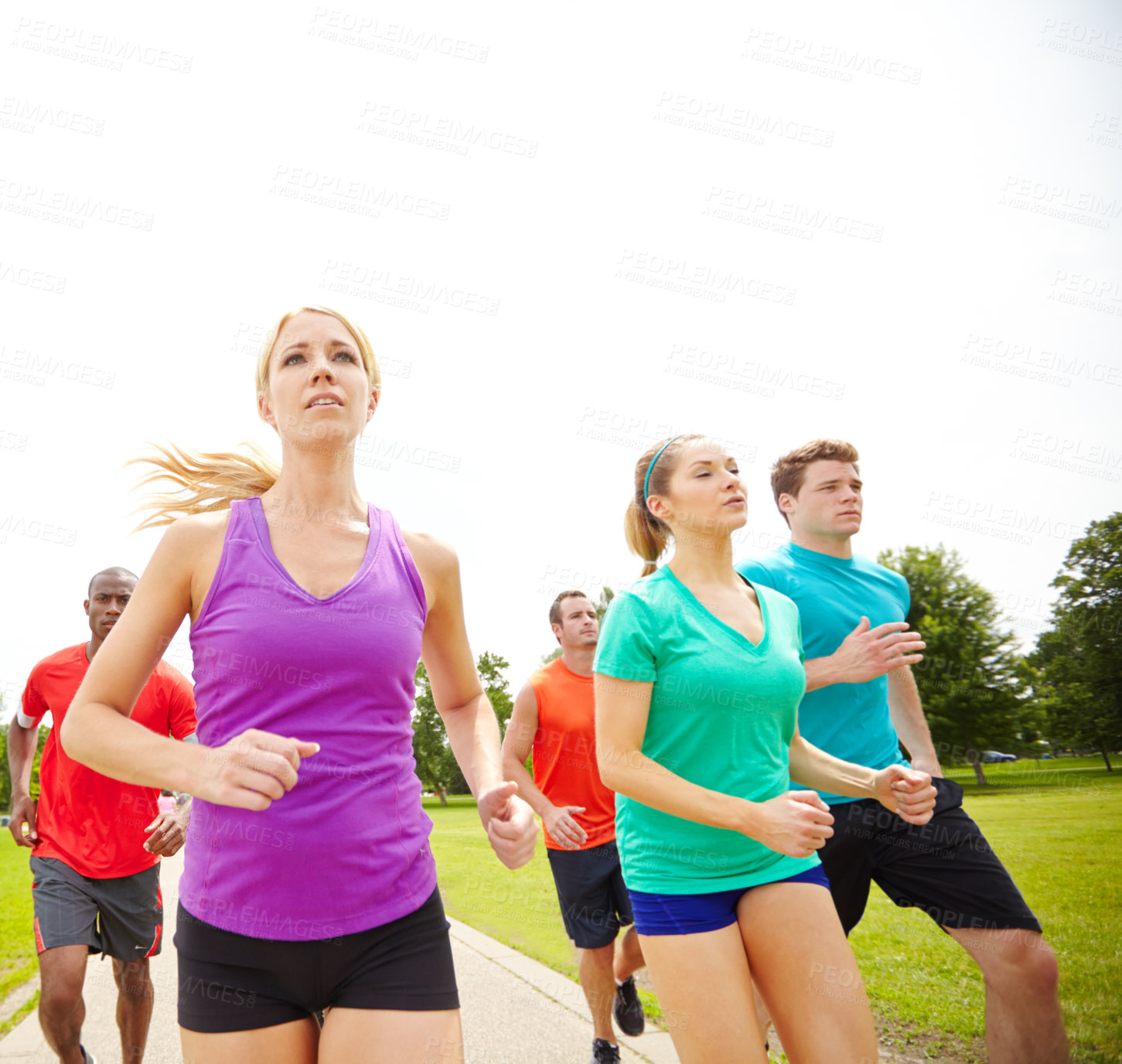 Buy stock photo Front view of a group of runners exercising outdoors
