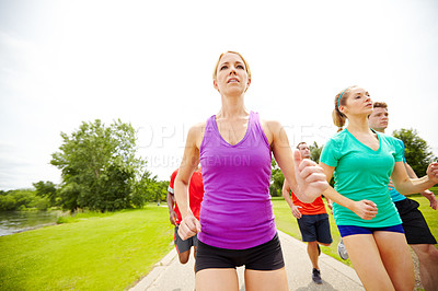 Buy stock photo Front view of a group of runners on an outdoor track