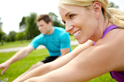 Buy stock photo Close up side view of a female athlete stretching outdoors