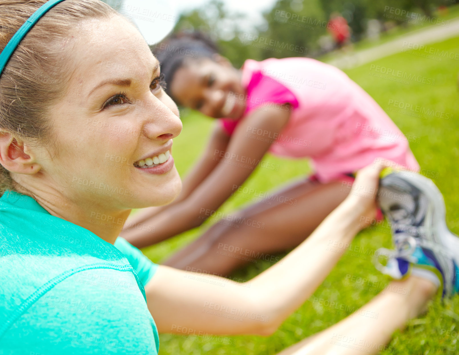 Buy stock photo Close up cropped shot of a female runner cooling down on the grass