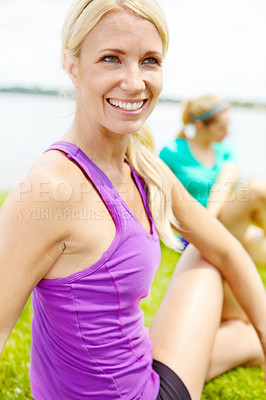 Buy stock photo Close up of a female athlete looking away from the camera while stretching outdoors
